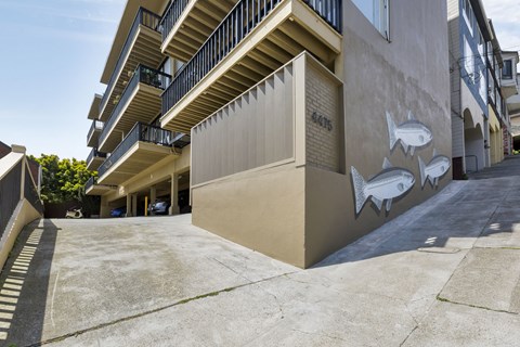 A building with a mural of fish on the side.
