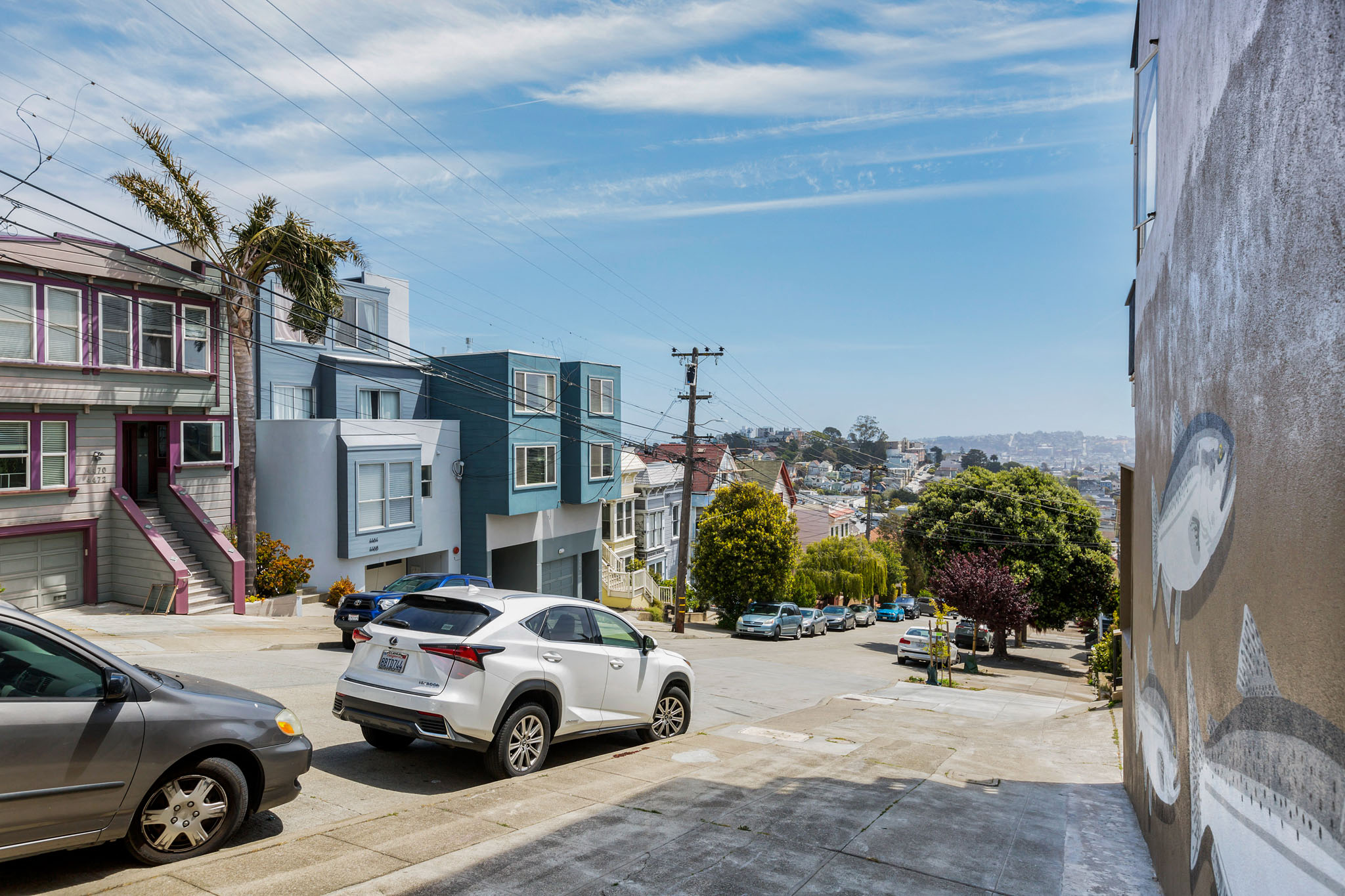 A street view with cars and buildings.