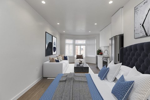 A modern living room with a white sofa and a grey rug.