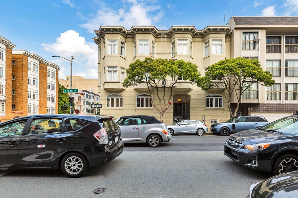 A black car is parked on the left side of the street.
