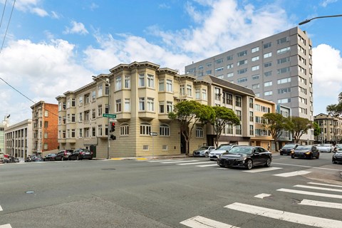 A street view of a city with cars and buildings.