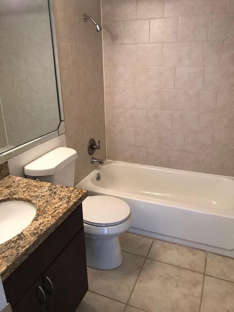 a bathroom with a toilet and a tub and a sink