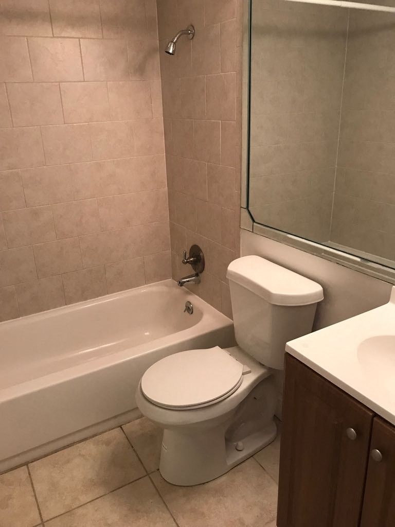 a bathroom with a toilet and a bath tub