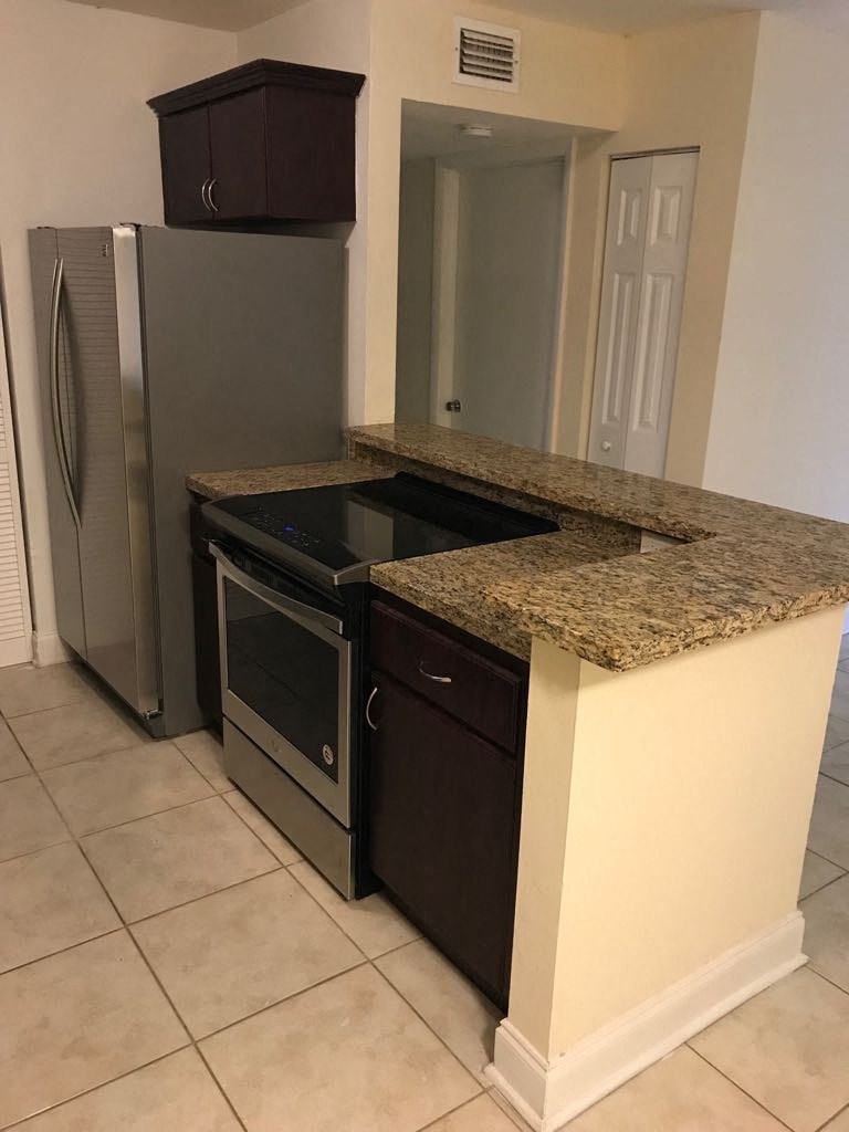 a kitchen with a stove and a refrigerator