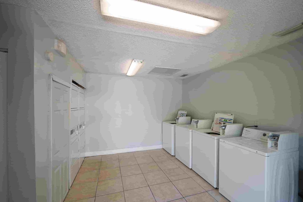 a laundry room with washes and dryers in it