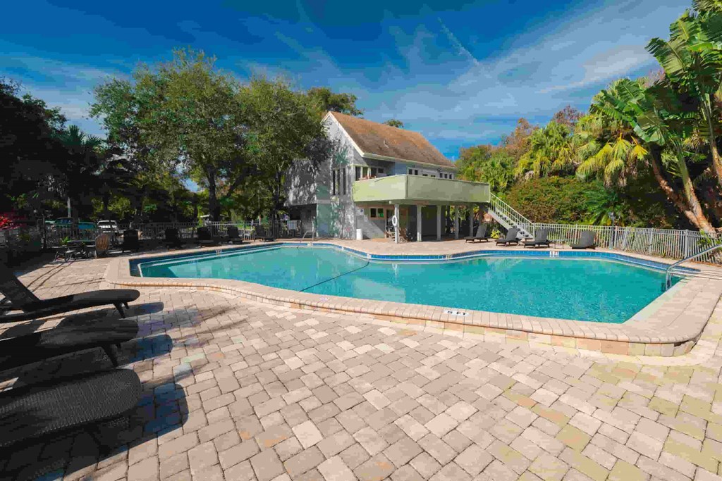 a swimming pool with a house in the background