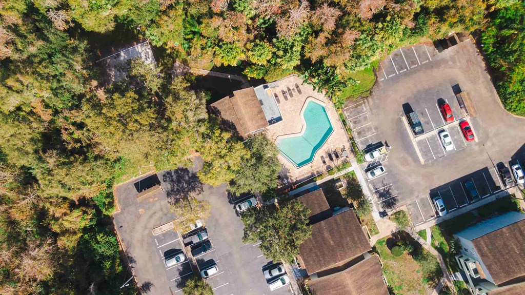 a birds eye view of a pool in the middle of some houses