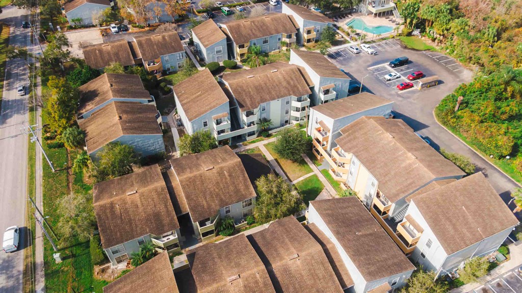 an aerial view of a neighborhood of houses with roofs