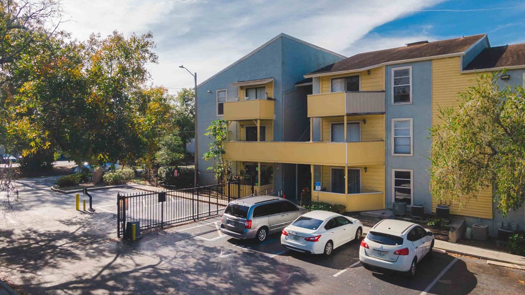 an apartment building with cars parked in front of it