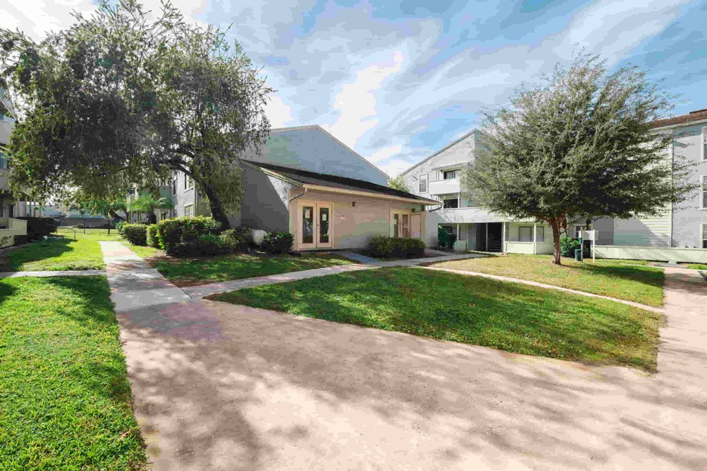 a house with a driveway and lawn in front of it