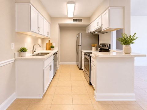A kitchen with white cabinets and appliances.