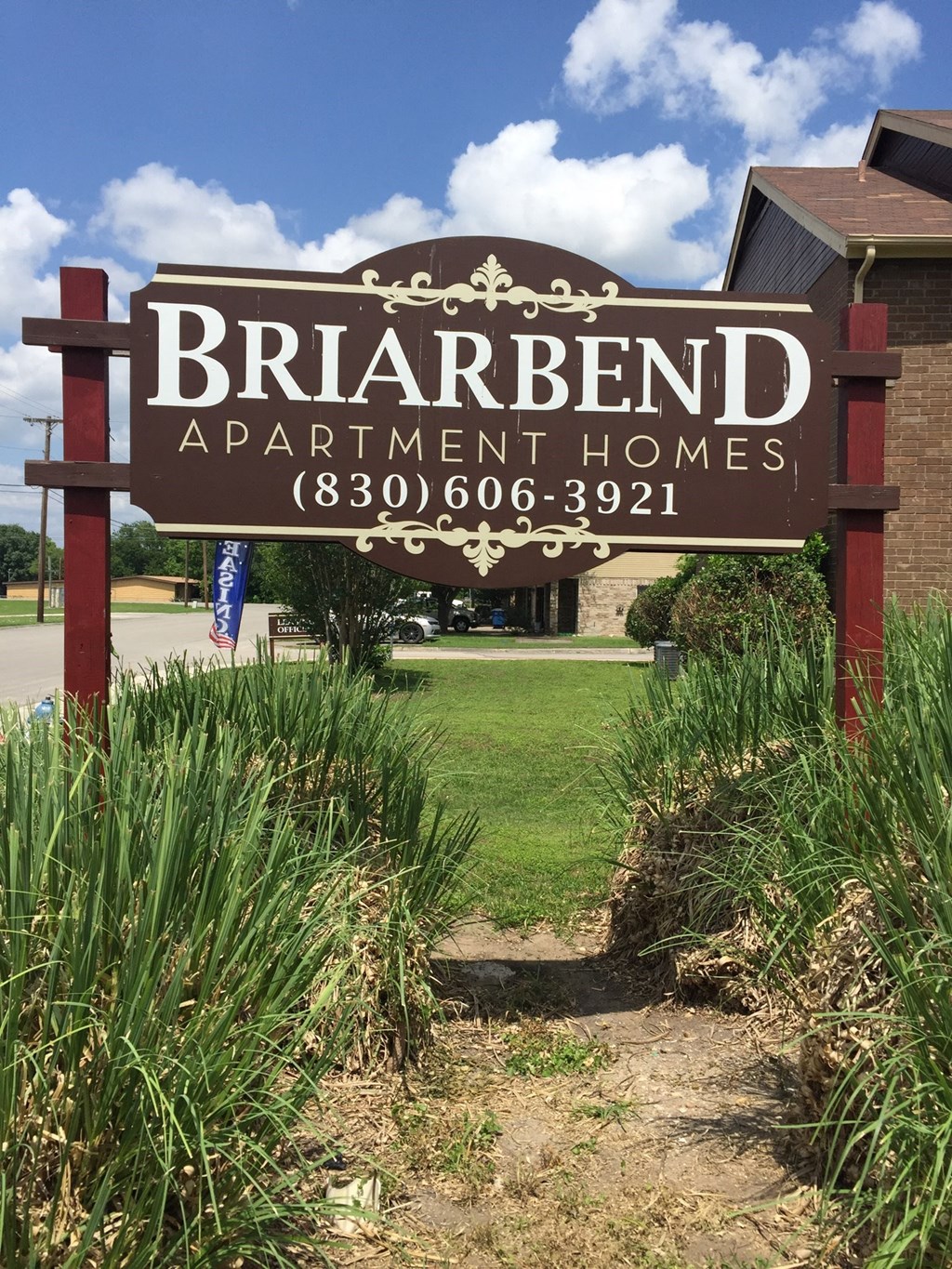 a sign apartment homes in front of a lawn