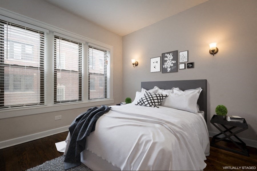 a bedroom with a bed and three windows