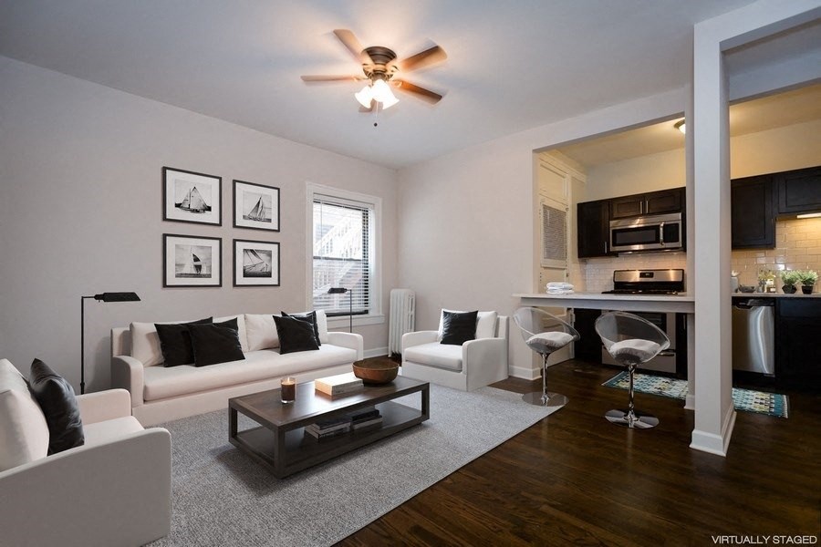 a living room with white couches and a coffee table