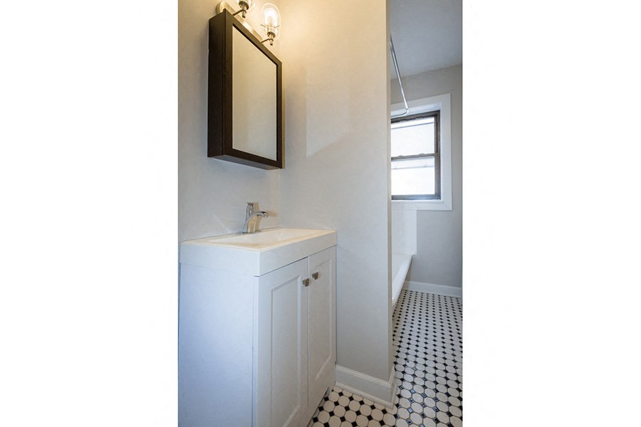 a small bathroom with a sink and a mirror