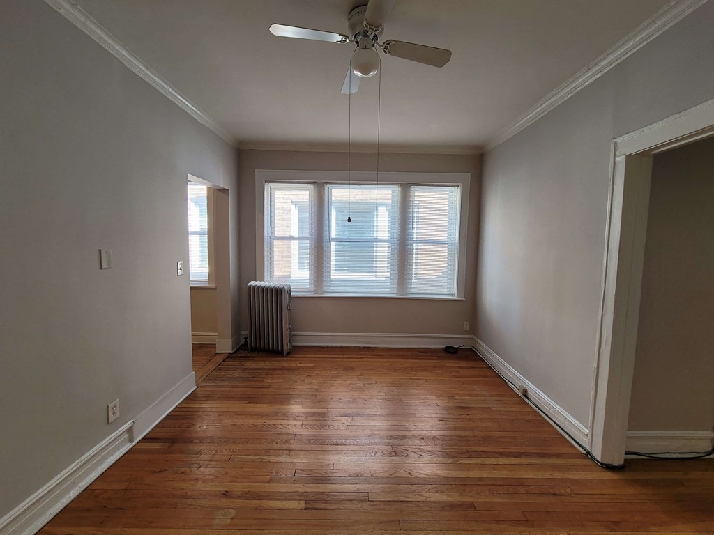 a living room with a ceiling fan and a window