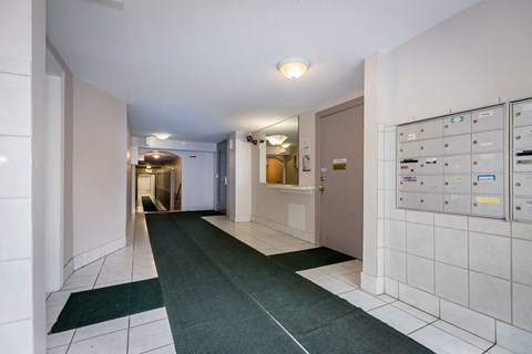 a long hallway with tile floors and a locker room