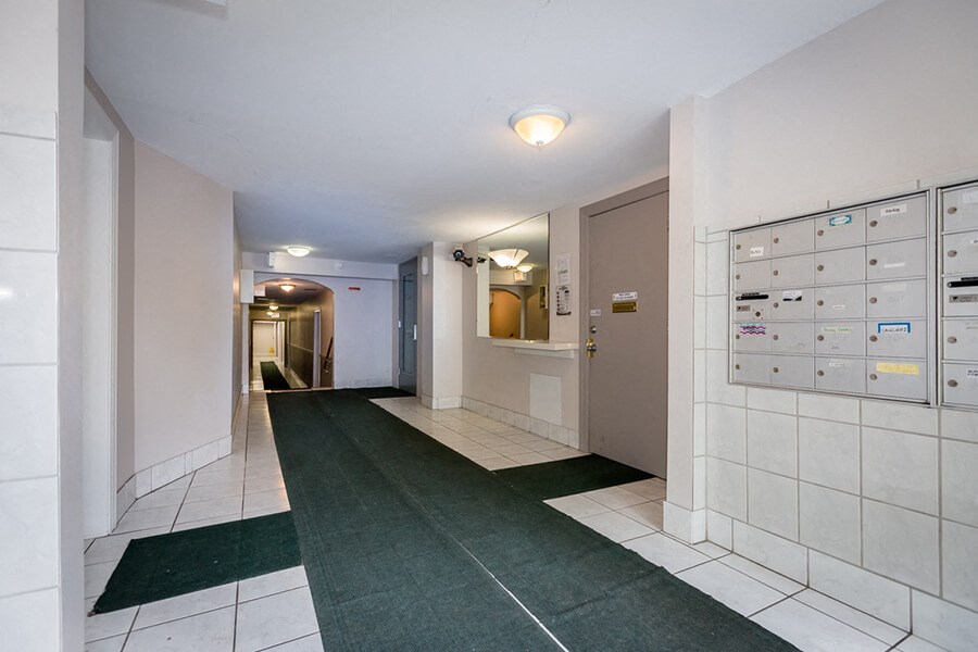 a long hallway with tile floors and a locker room