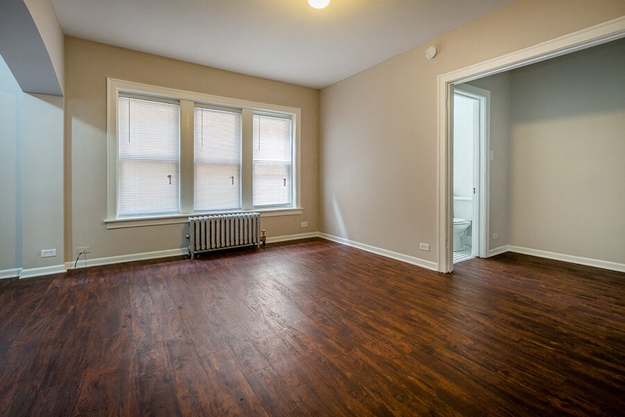 the living room of an empty house with wood floors