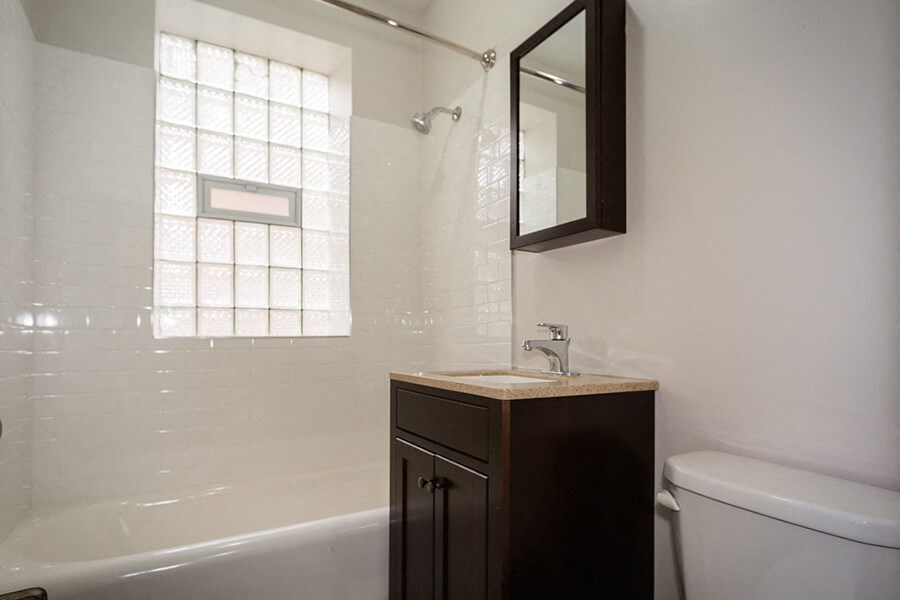 a bathroom with a sink and a toilet and a bath tub