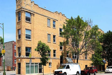 a large brick building with a van parked in front of it