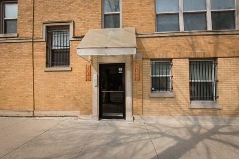 the front of a brick building with a black door