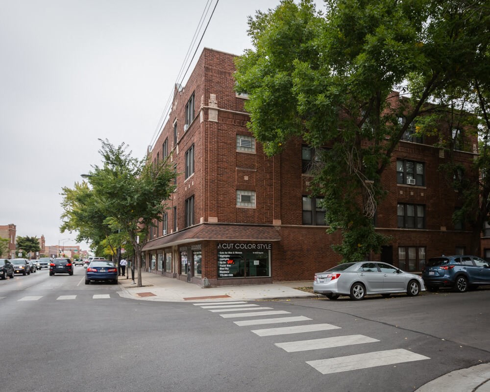 a brick building on the corner of a city street