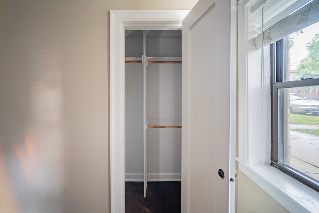 a closet in a small room with a window