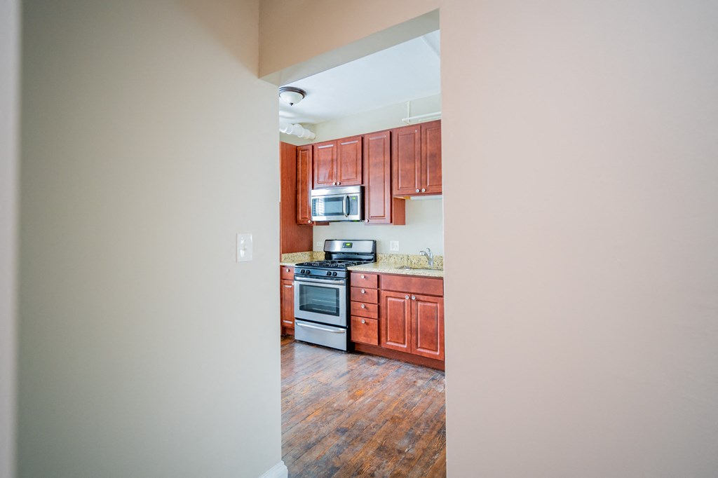full view of kitchen with wood cabinets and appliances in an empty house