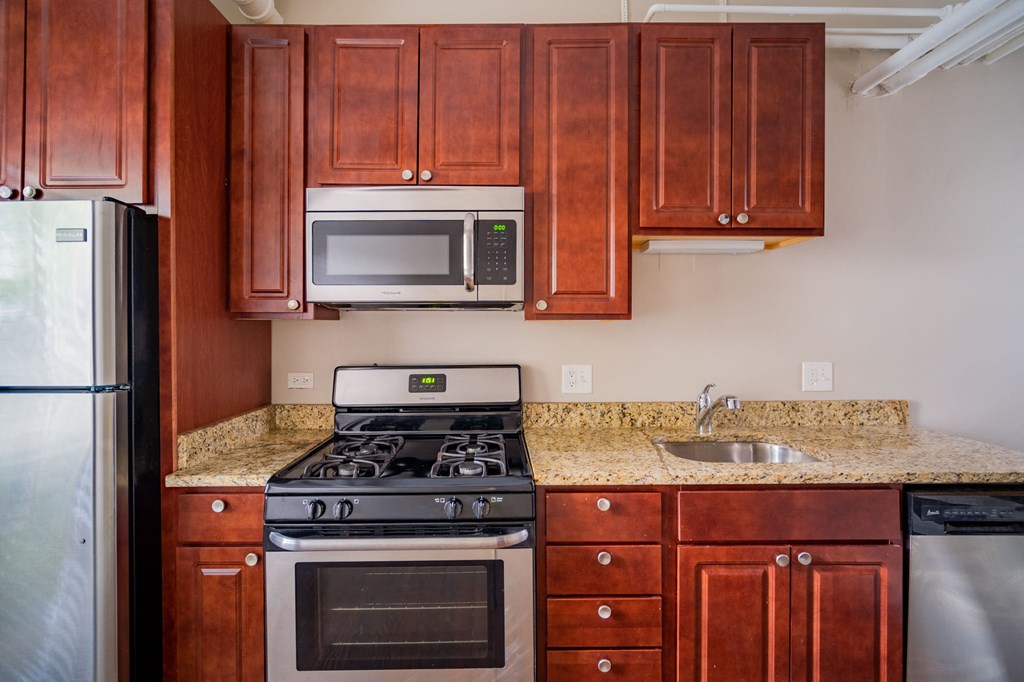 a kitchen with a stove microwave and sink