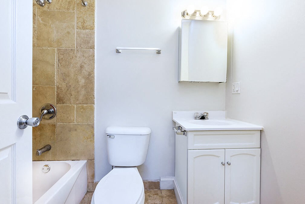 a bathroom with a toilet and a sink and a shower