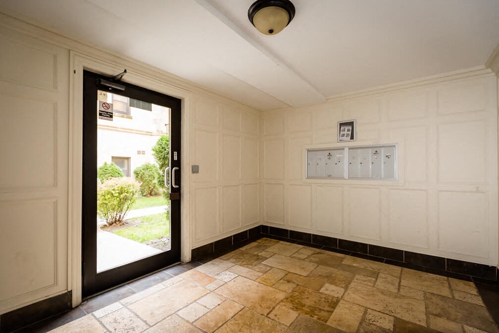 the living room of the house has a door to the yard