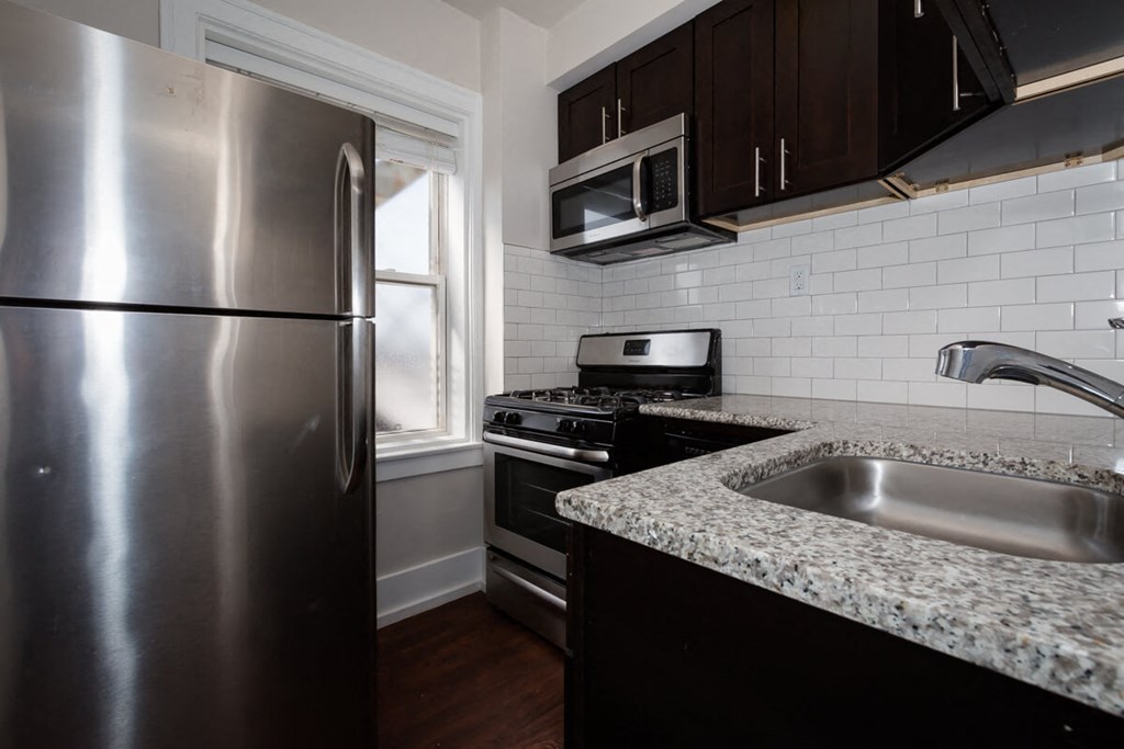a kitchen with granite counter tops and stainless steel appliances