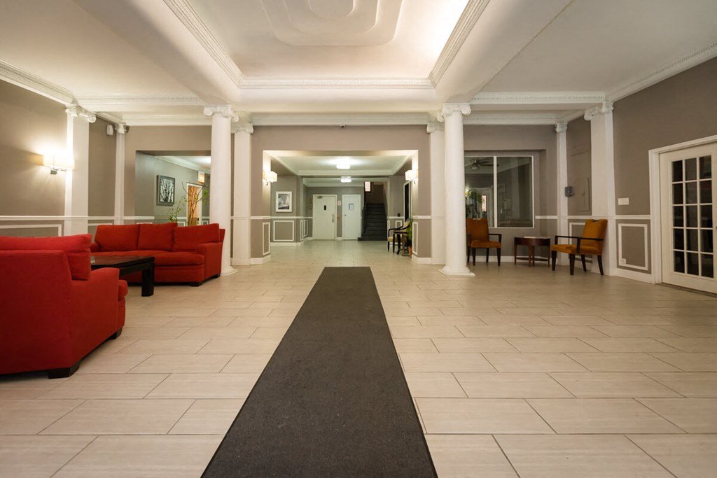 a large lobby with couches and chairs and a rug