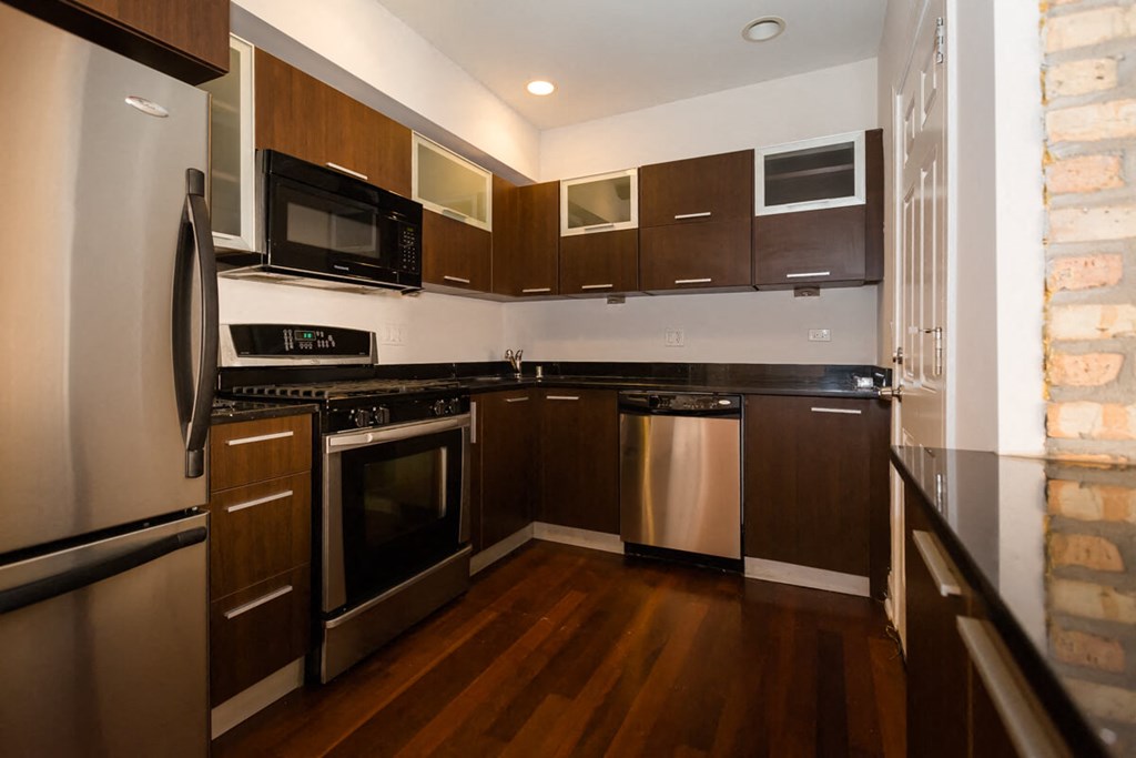 a kitchen with stainless steel appliances and wooden cabinets