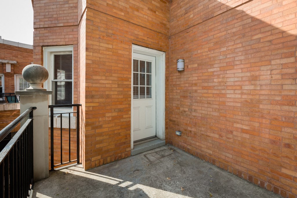 the entrance to a brick building with a white door