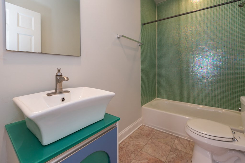 a bathroom with a sink and a shower and a toilet