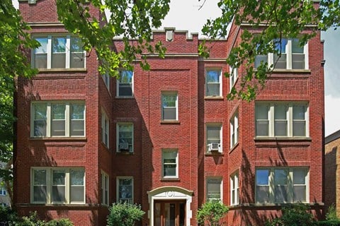 a red brick building with trees in front of it