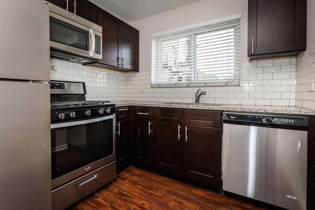 a kitchen with stainless steel appliances and a window