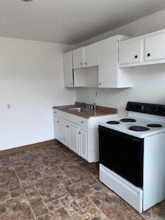 A kitchen with a black stove top oven and white cabinets.