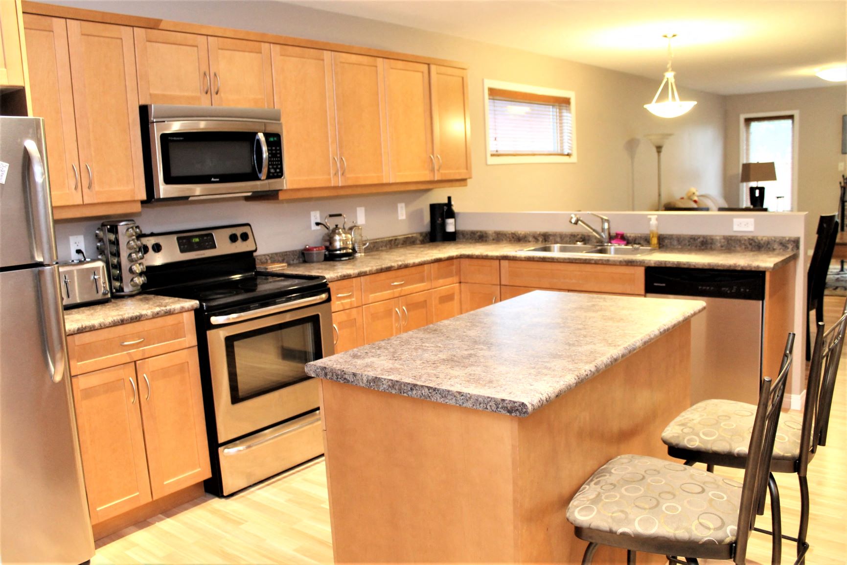 a kitchen with stainless steel appliances and wooden cabinets