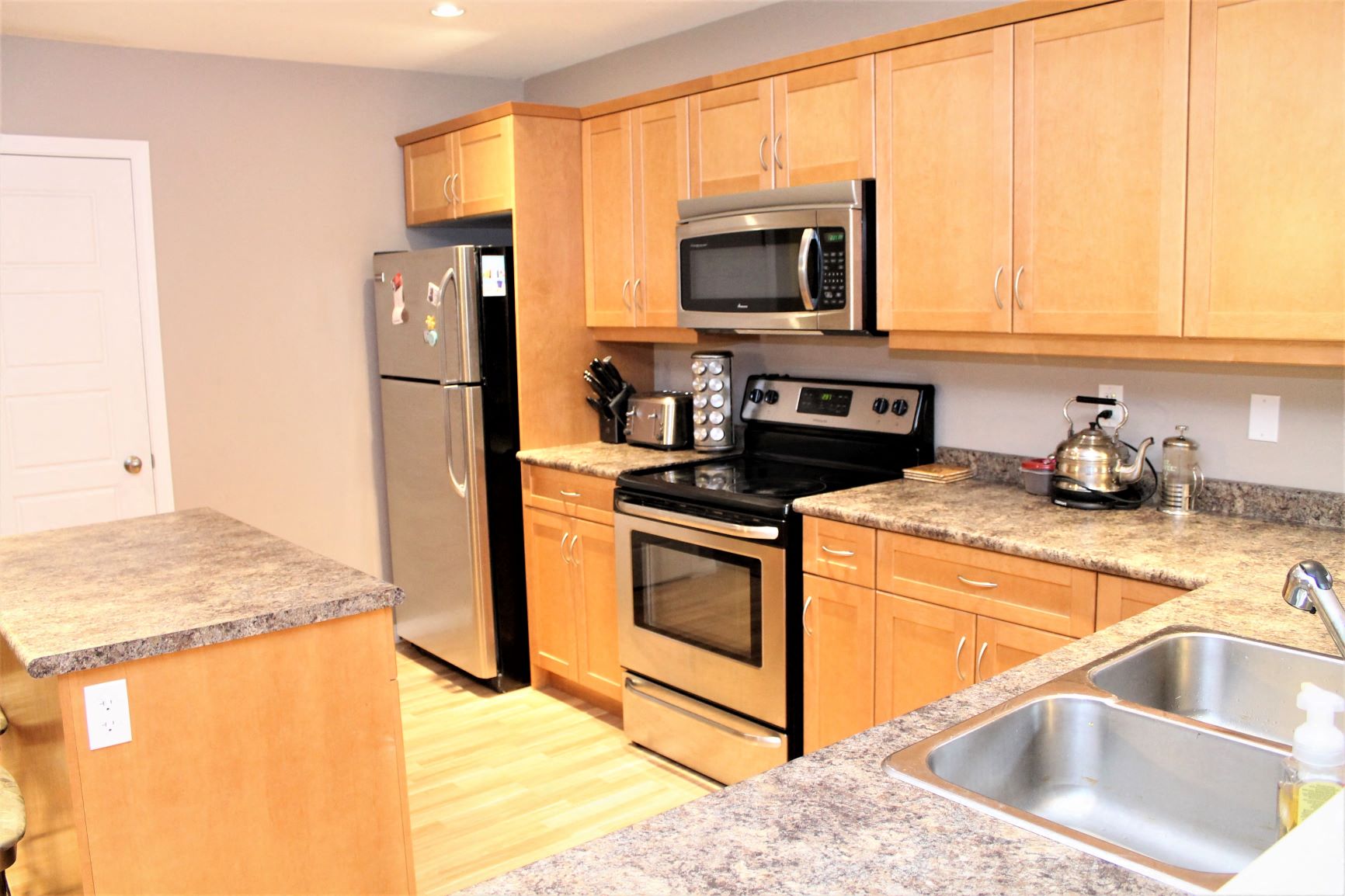 a kitchen with stainless steel appliances and wooden cabinets