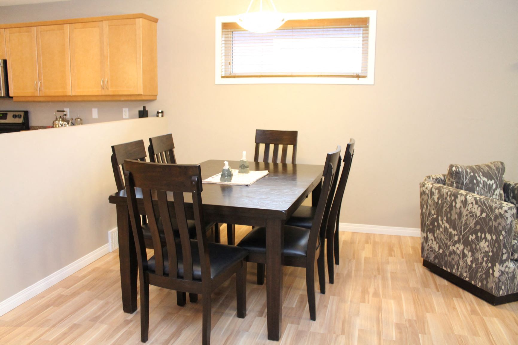 a dining room with a wooden table and chairs