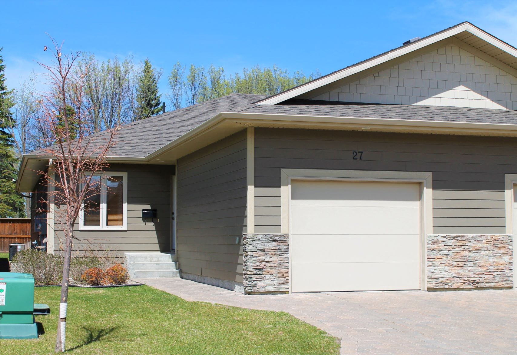 a gray house with a white garage door