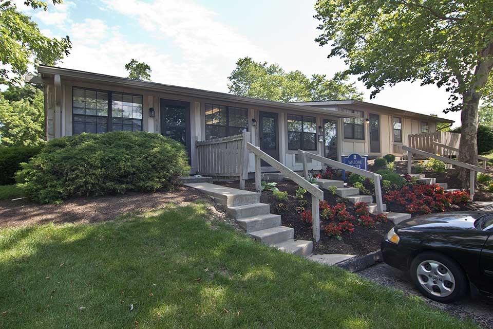 a house with a porch and stairs in front of it