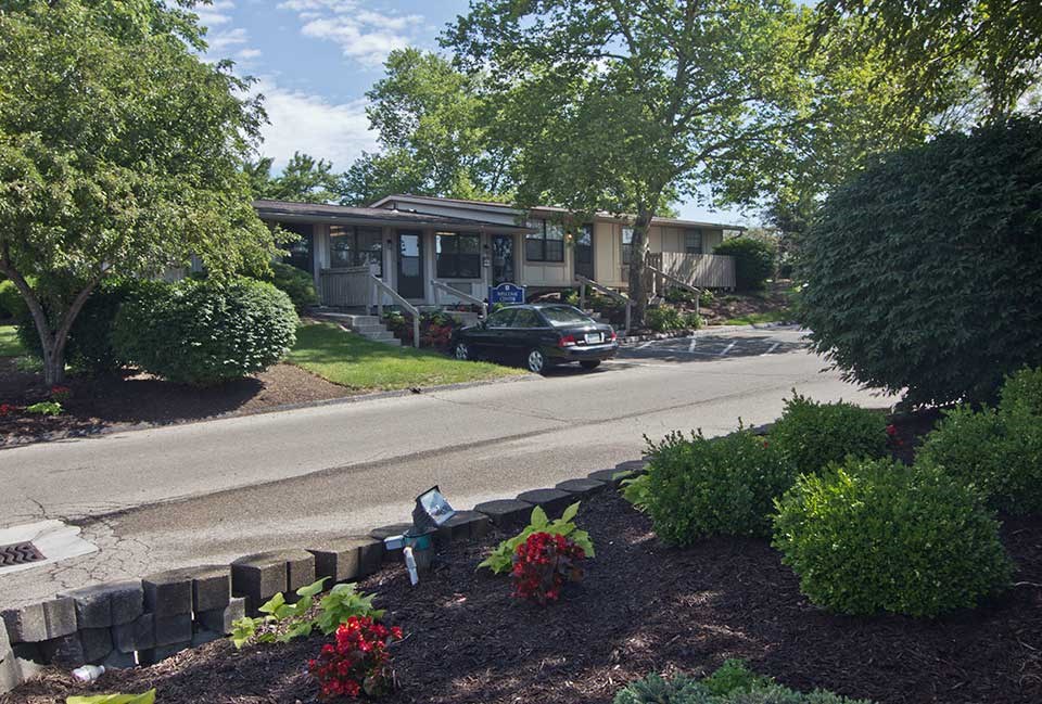 a car parked in front of a house on a street