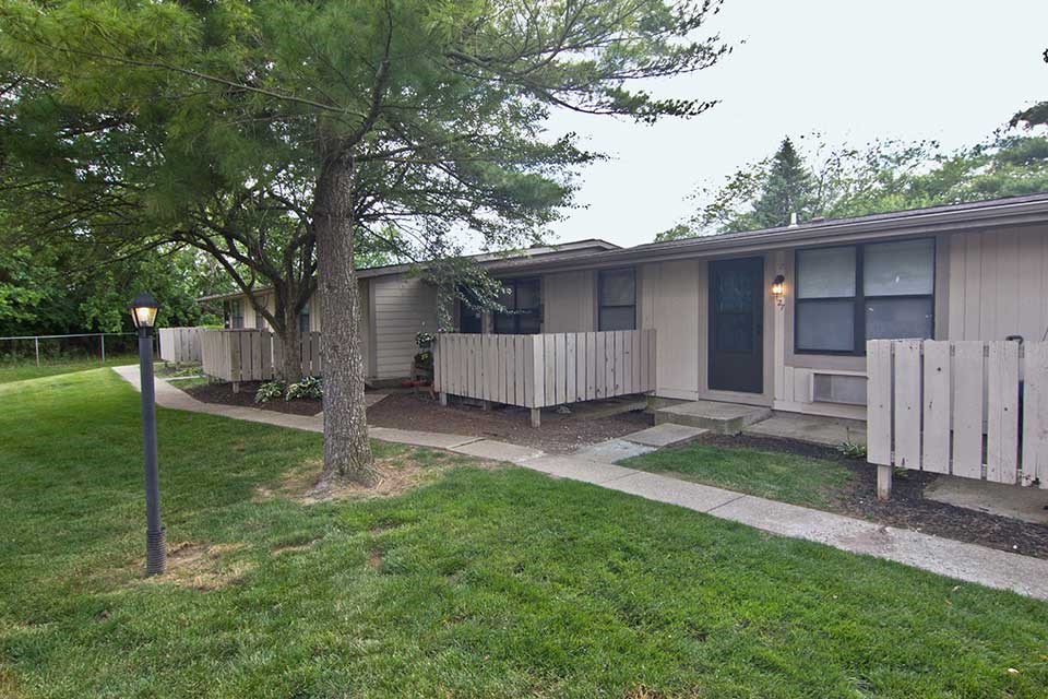 a small house with a yard and a sidewalk