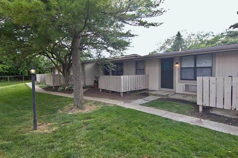 a small house with a yard and a sidewalk