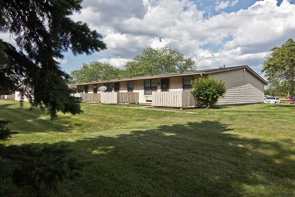 a white house with a yard in front of it