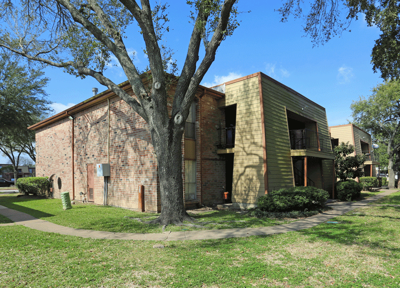 a brick building with a tree in front of it